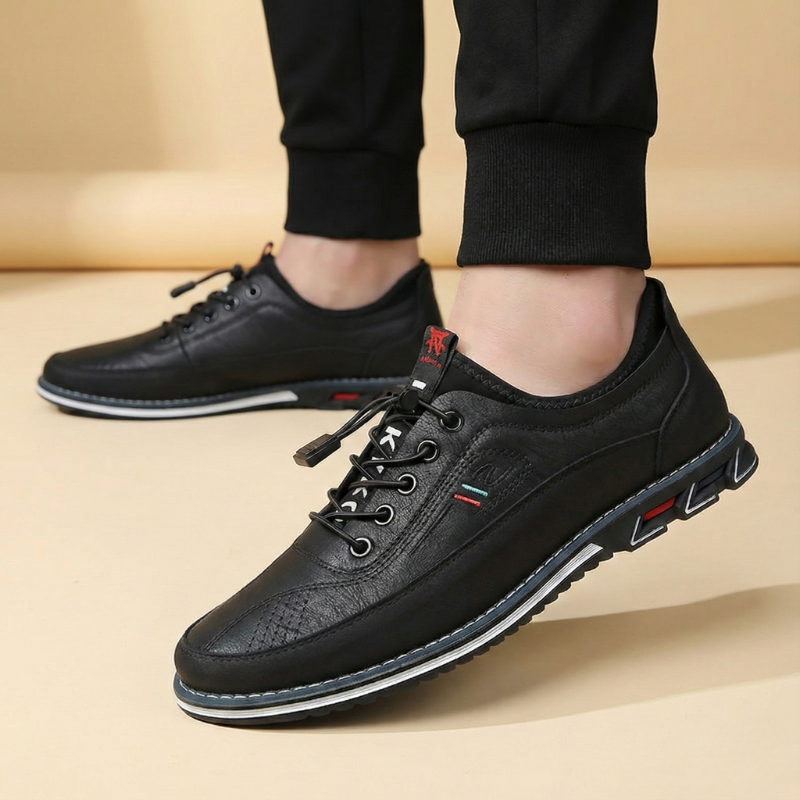 Czarne sneakersy męskie na stopach modela, ujęcie z przodu w pozycji stojącej.