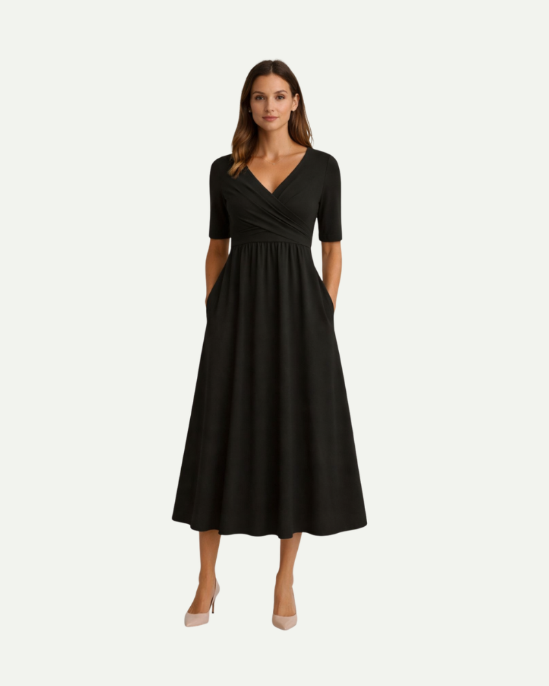 Modelka w czarnej sukience midi dekolt V krótki rękaw elegancka