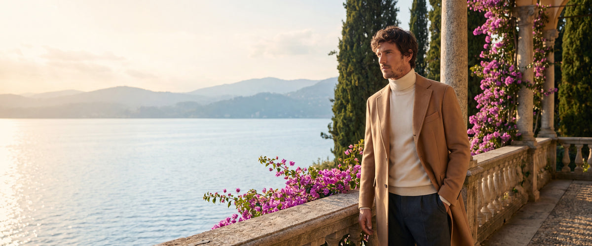 Old money man standing on balcony wearing coat and turtleneck